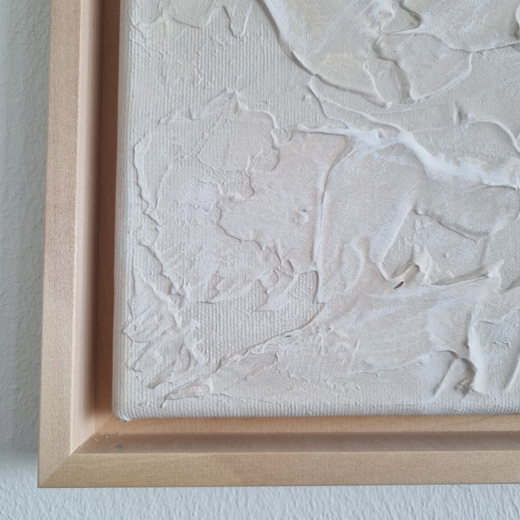 Light beige monochromic textured painting with wooden floating frames.
