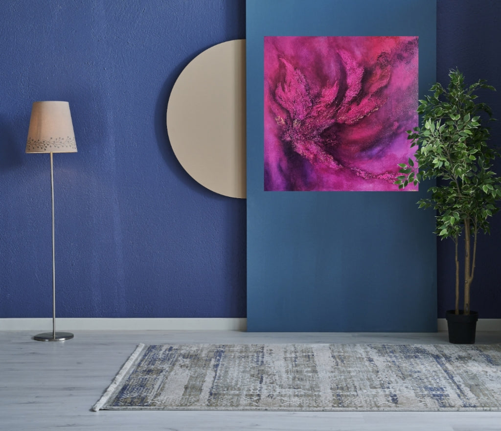 Large contemporary pink purple abstract art hanging in the blue wall.